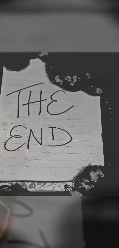 Burnt paper with 'The End' text on a dark background wallpaper.