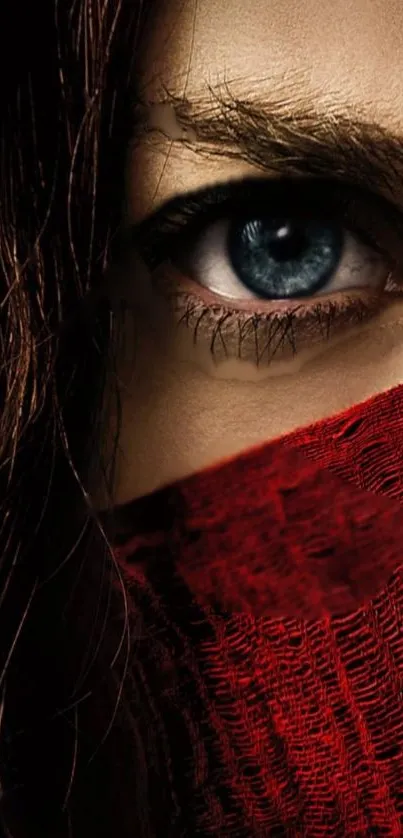 Close-up of a blue eye with a red cloth covering face, dramatic and intense.