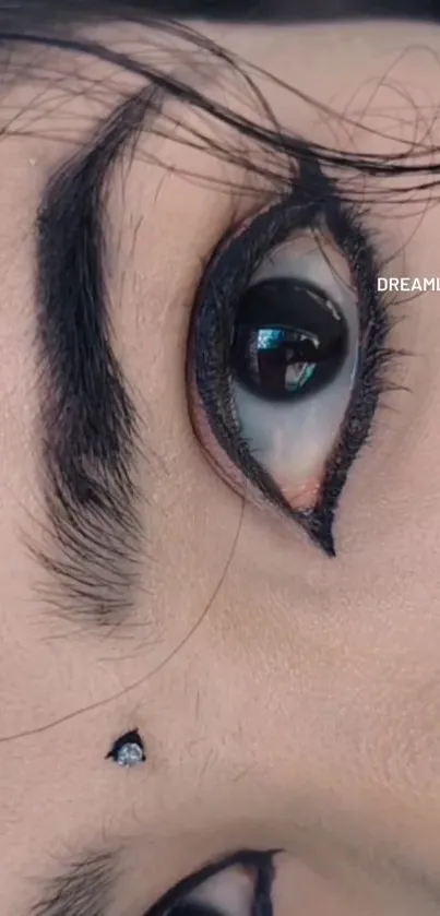 Close-up of an eye with bold eyeliner and intricate details.