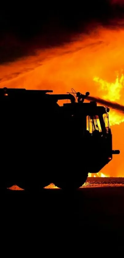 Silhouette of a fire truck with intense orange flames.