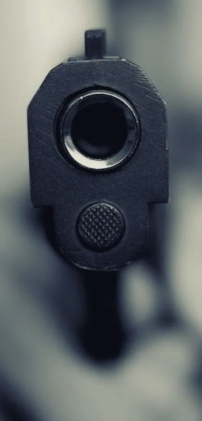 Close-up view of a gun barrel with a dramatic focus.