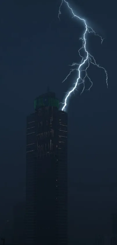 Dramatic lightning strikes a dark skyscraper at night.