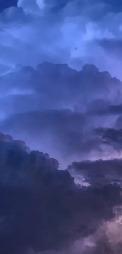 Dramatic purple and blue storm clouds in a night sky wallpaper.