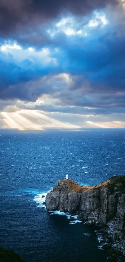 Dramatic ocean view with sunlit cliff and cloudy sky.