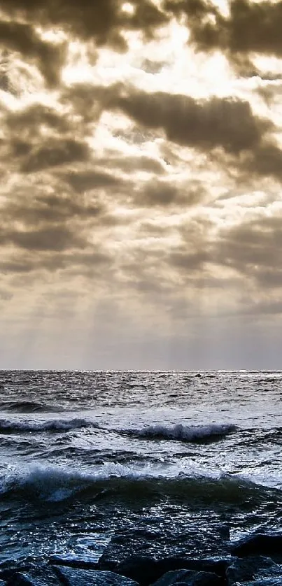 Dramatic ocean scene with cloudy sky.