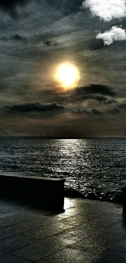 Dramatic ocean sunset with cloudy sky and shimmering reflections.