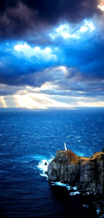 Dramatic ocean view with cliffs and lighthouse under a vibrant sky.