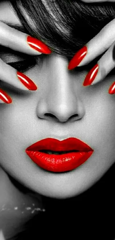 Monochrome face with red lips and nails in artistic style.