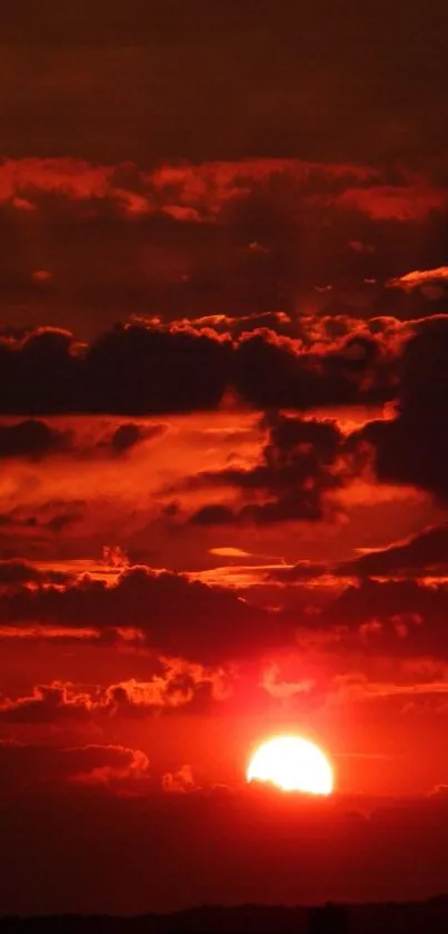 Fiery red sunset with dramatic cloud formations.