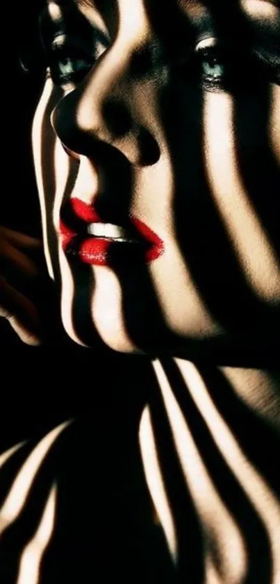 Dramatic portrait with shadows and bold red lips on a dark wallpaper.