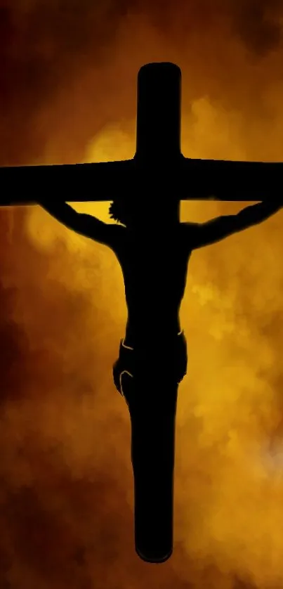 Silhouette of crucifix against fiery cloud background.