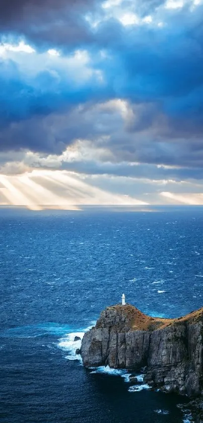 Dramatic sky and ocean with distant lighthouse on a cliffside.