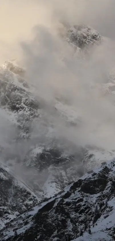 Snowy mountain peaks shrouded in mist and clouds.