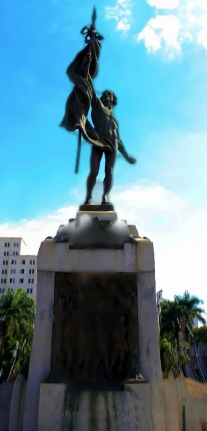 Dramatic statue against a vibrant blue sky.