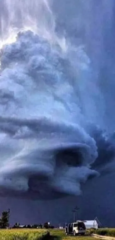 Dramatic storm cloud forming over landscape with vivid sky.