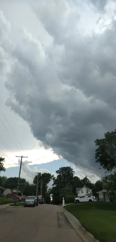 Dramatic stormy sky over a suburban street with dark clouds and greenery.