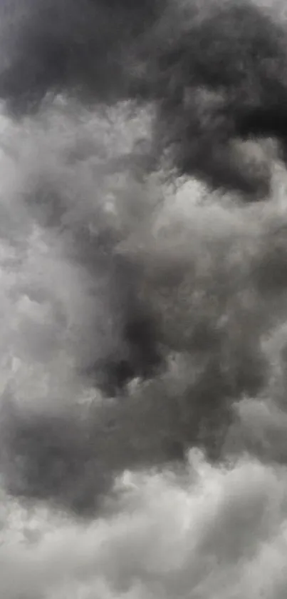 Dramatic clouds with a stormy sky in gray tones wallpaper.