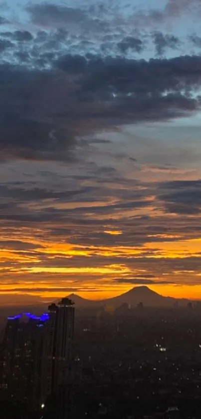 City skyline at sunset with orange sky and clouds.