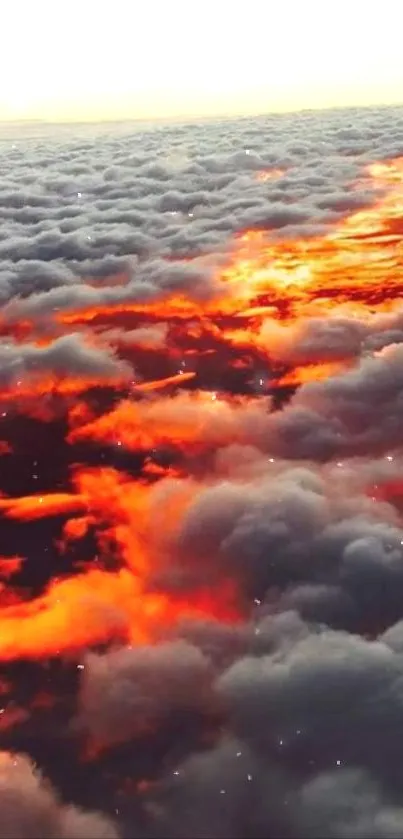 Dramatic sunset cloudscape with fiery orange light above clouds.