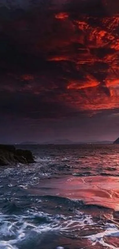 Dramatic ocean sunset with vibrant red sky over dark waters.