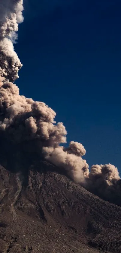 Dramatic volcanic eruption with plumes of smoke against a dark blue sky.