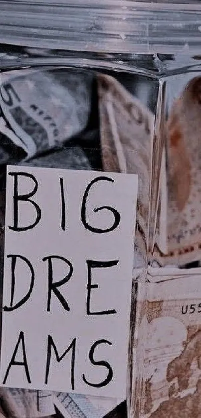 Glass jar with currency labeled 'Big Dreams' for inspiration.