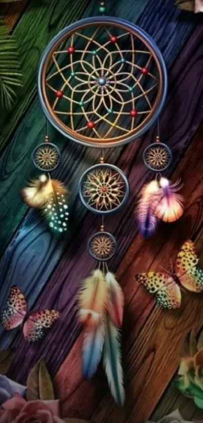 Colorful dreamcatcher with feathers and butterflies on a wooden background.