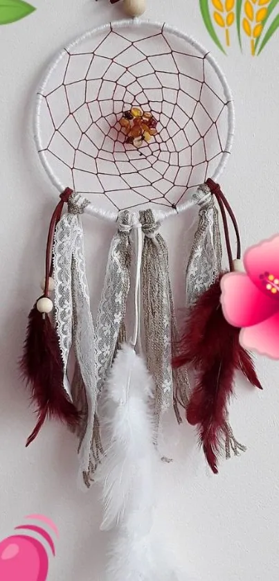 Dreamcatcher with flowers and feathers on white.