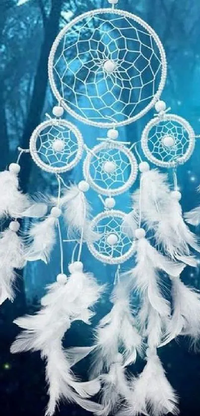 Dreamcatcher with white feathers in a mystical blue forest.