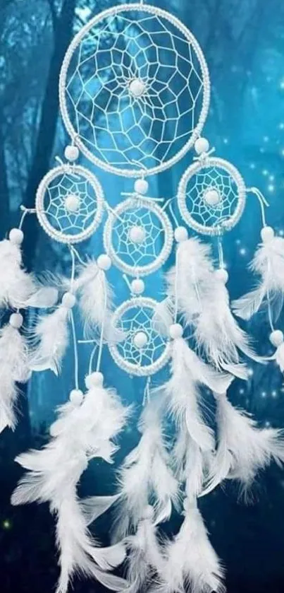 Dreamcatcher with feathers in a mystical blue forest background.