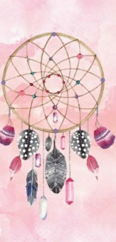 Dreamcatcher with feathers on pastel pink background wallpaper.