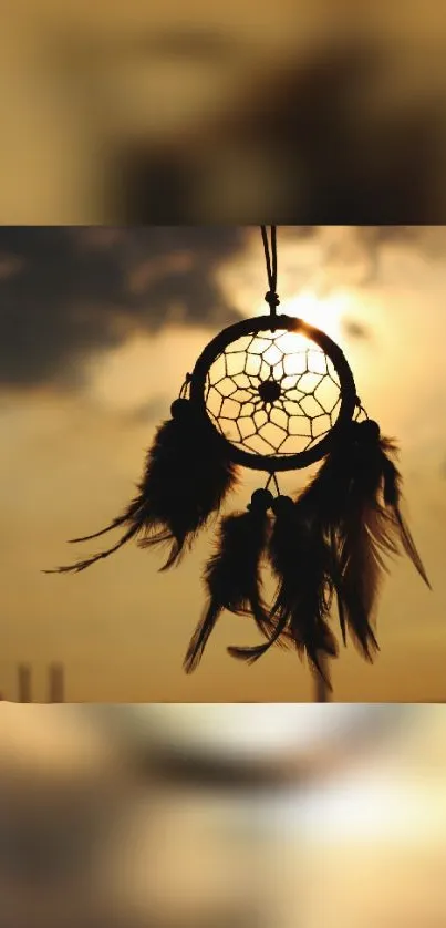 Dreamcatcher silhouetted against a brown sunset sky.