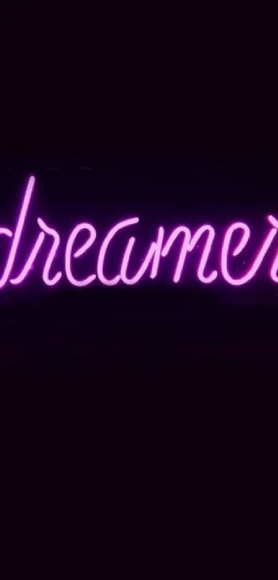 Dreamer in pink neon on black background wallpaper.