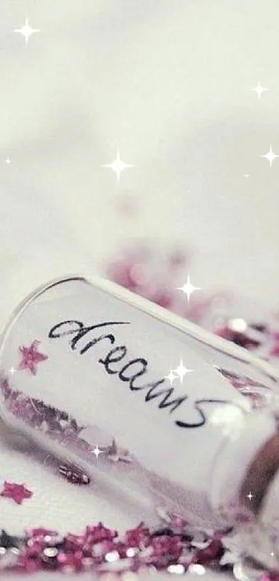 A glass bottle labeled 'dreams' with pink confetti stars in a soft, dreamy setting.