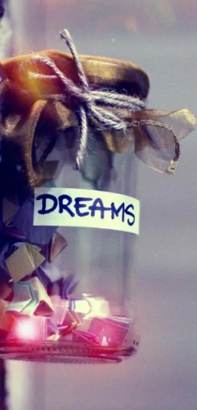 Glass jar filled with colorful paper stars labeled 'dreams' hanging on a wall.