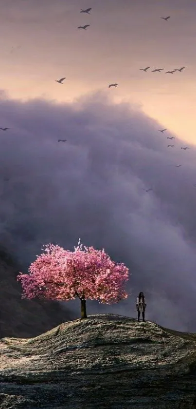 Cherry blossom tree atop rocky hill under dreamy sky.