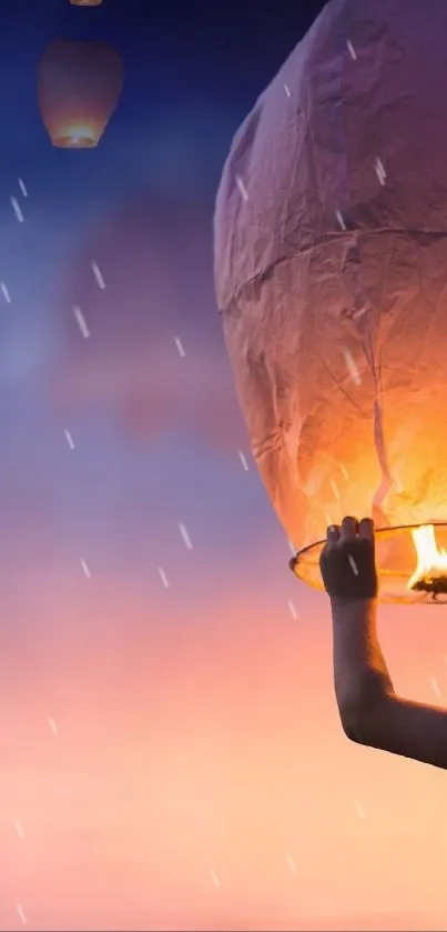 A child launches a glowing lantern into a colorful twilight sky.