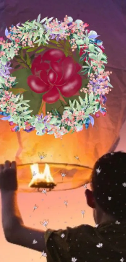 Child releasing lantern with floral art in a warm orange glow.