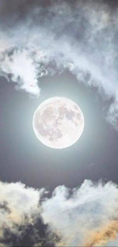 Full moon with surrounding clouds in a tranquil night sky.