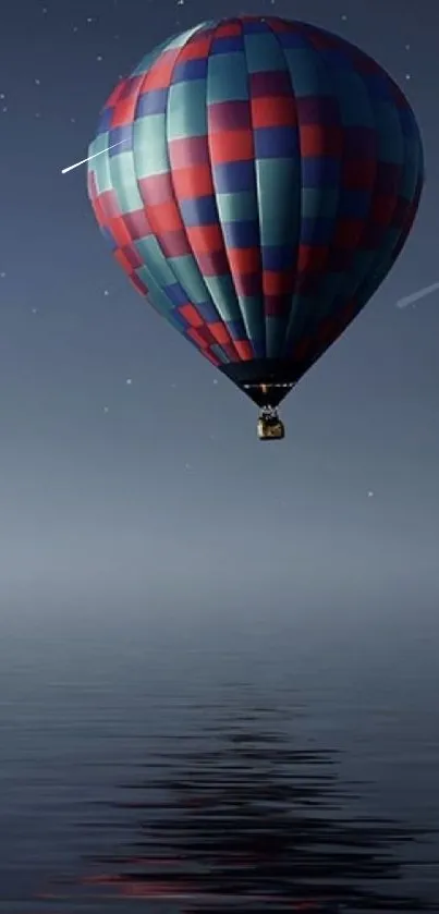 Hot air balloon under starry night sky reflecting on water.