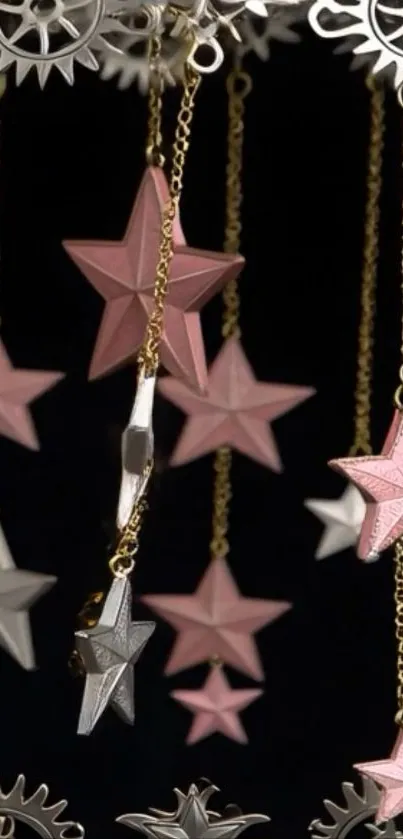 Mobile wallpaper with pink stars and gears hanging on chains.