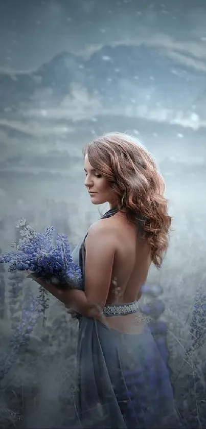 Woman in blue dress in a snowy landscape with mountains.