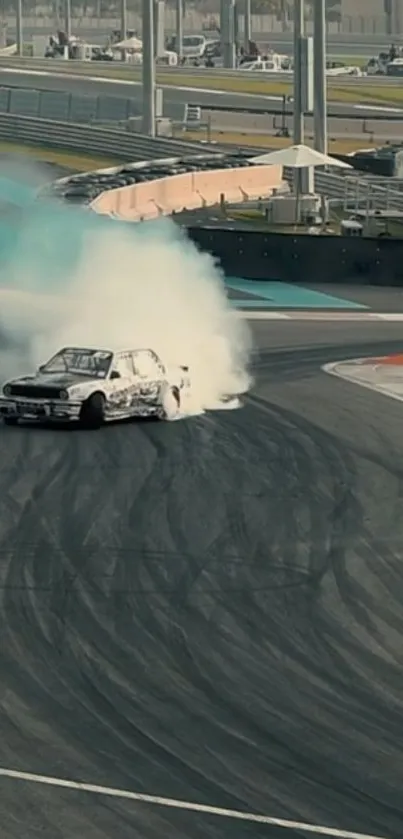 A car drifting on a race track with smoke trailing behind.