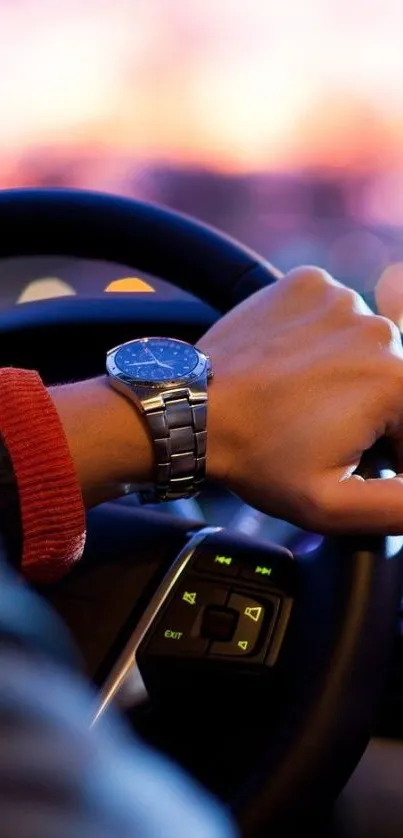 Hand on steering wheel at sunset with a watch, capturing elegance and style.