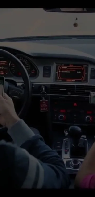 Car interior with phone navigation and dashboard.