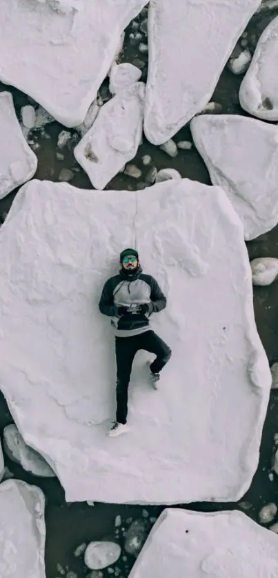 Man lying on Arctic ice with drone view.