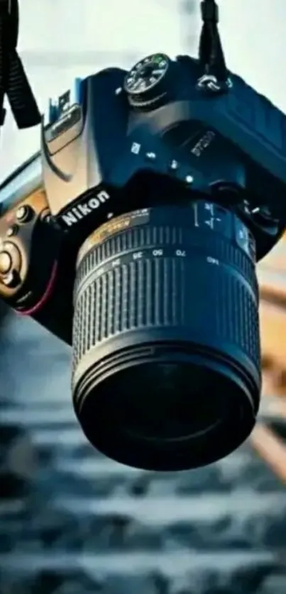 DSLR camera hanging over railway tracks, artistic wallpaper.