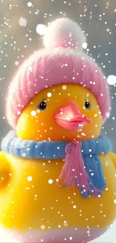 Yellow duck with pink hat in snowy setting.