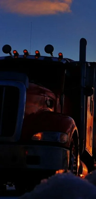 Silhouette of a truck at dusk with a vibrant sunset sky.