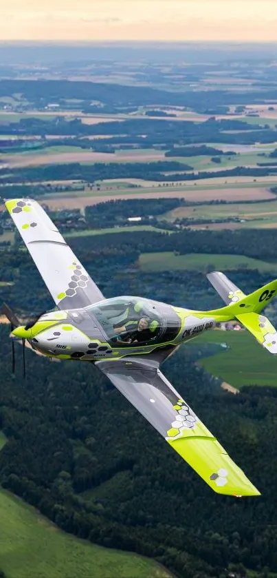 Vibrant aircraft flying over scenic landscape.